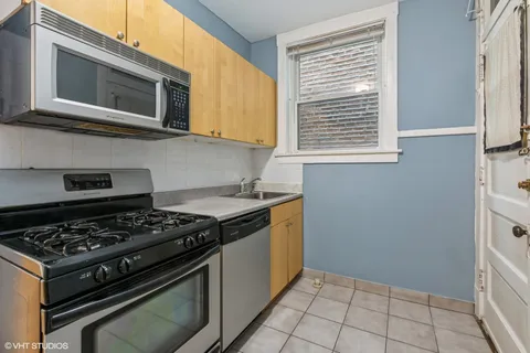 a kitchen with stainless steel appliances granite countertop a stove and a microwave