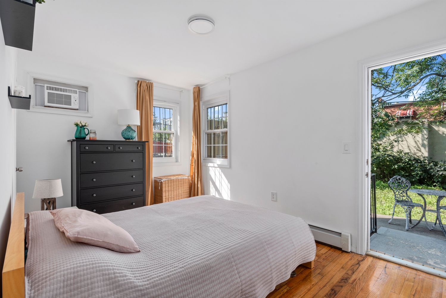 756 Barbey Street, Unit 1A Brooklyn, NY 11207 - Photo 3 of 9 a bedroom with a bed and a flat screen tv