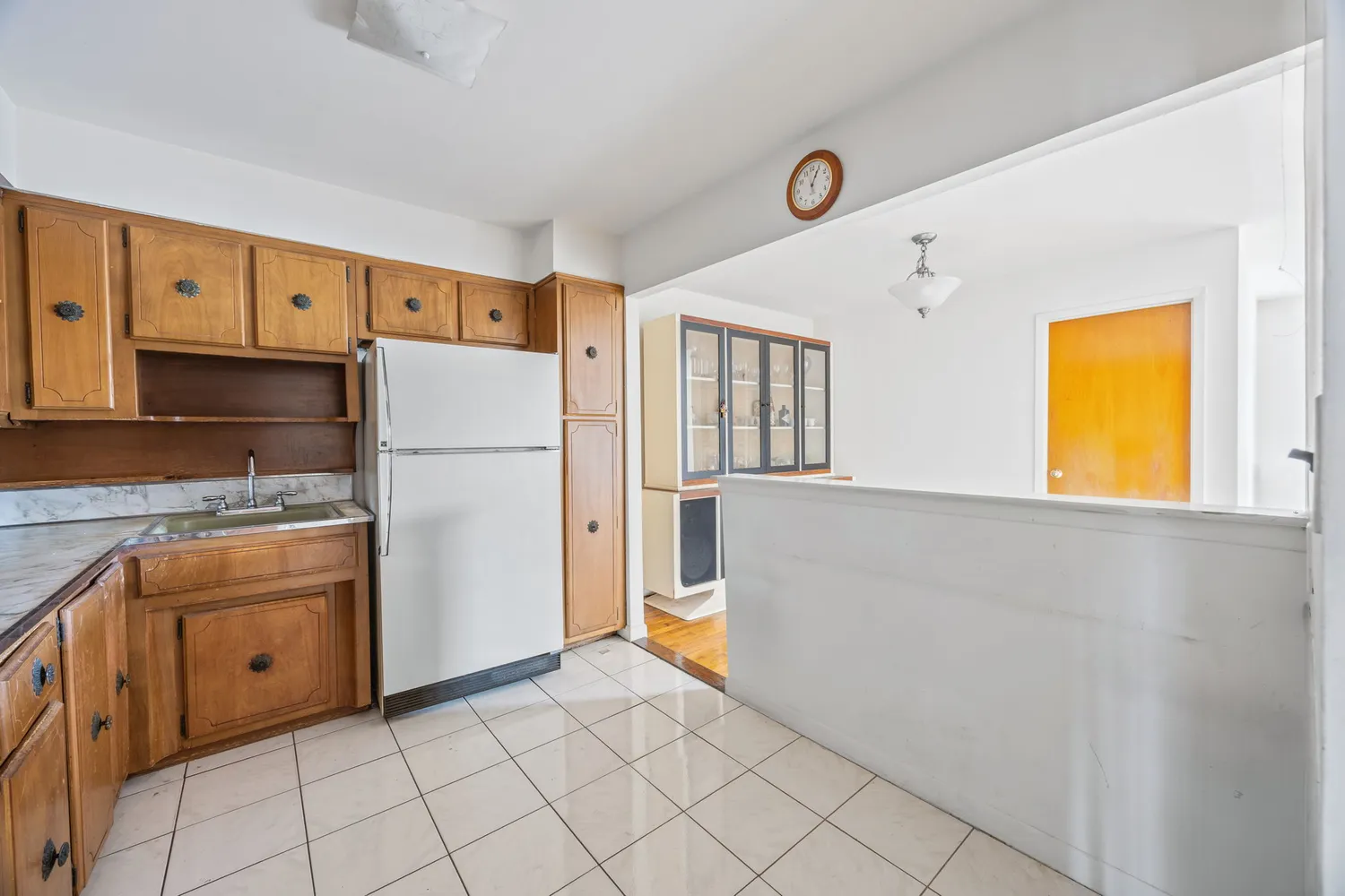 a kitchen with a refrigerator a stove top oven and cabinets