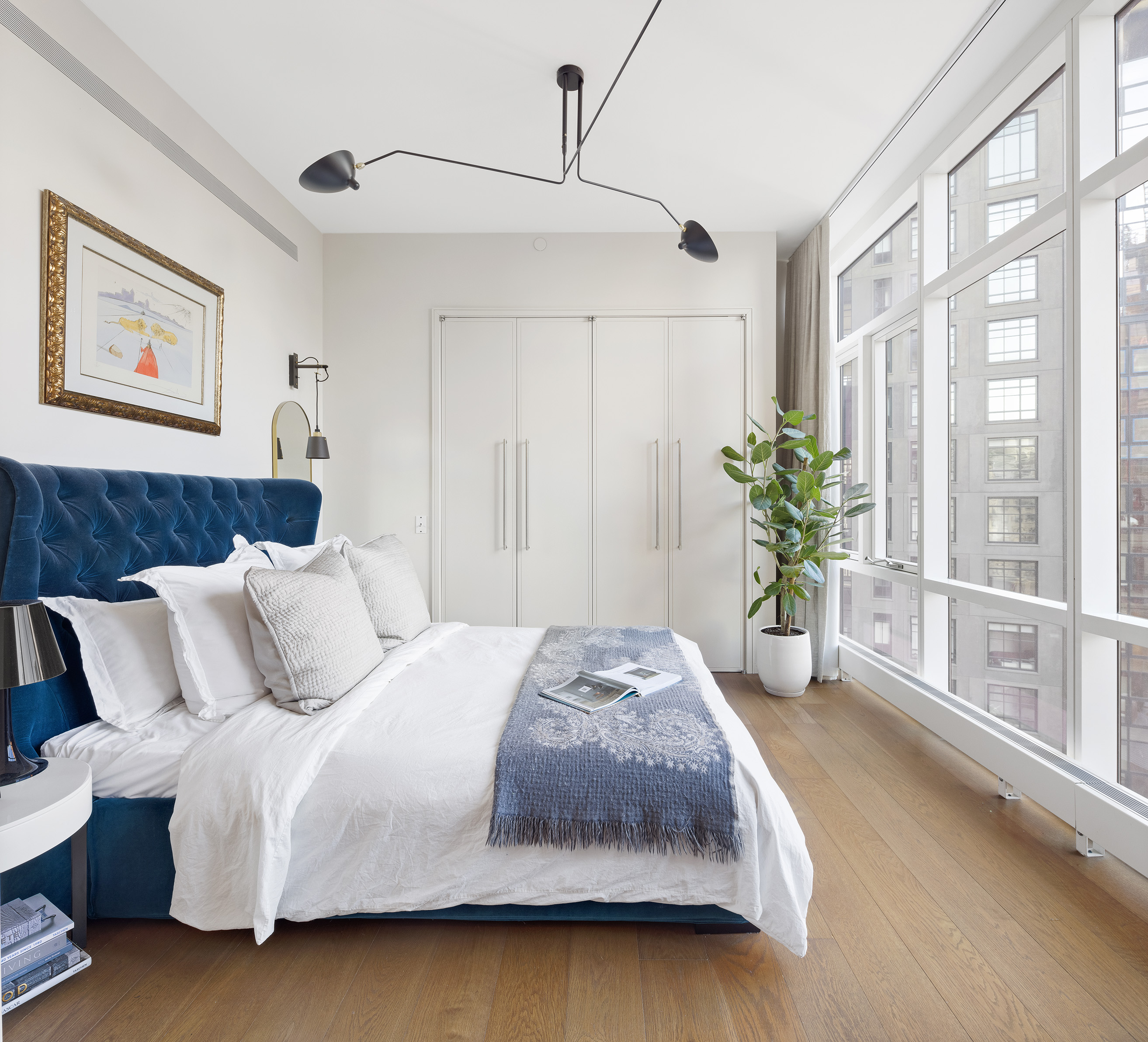 5 Beekman Street, Unit 20B Manhattan, NY 10038 - Photo 9 of 12 a bedroom with a large bed and a large window