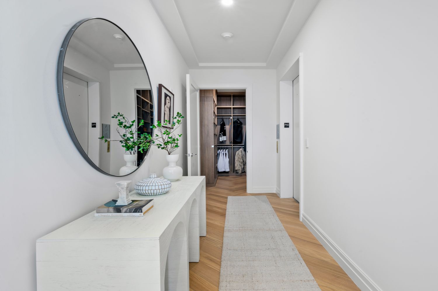 a view of a hallway with wooden floor and entryway