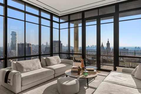 a living room with furniture and a floor to ceiling window