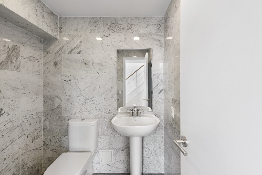 305 2nd Avenue, Unit 505 Manhattan, NY 10003 - Photo 10 of 17 a bathroom with a sink toilet and a mirror