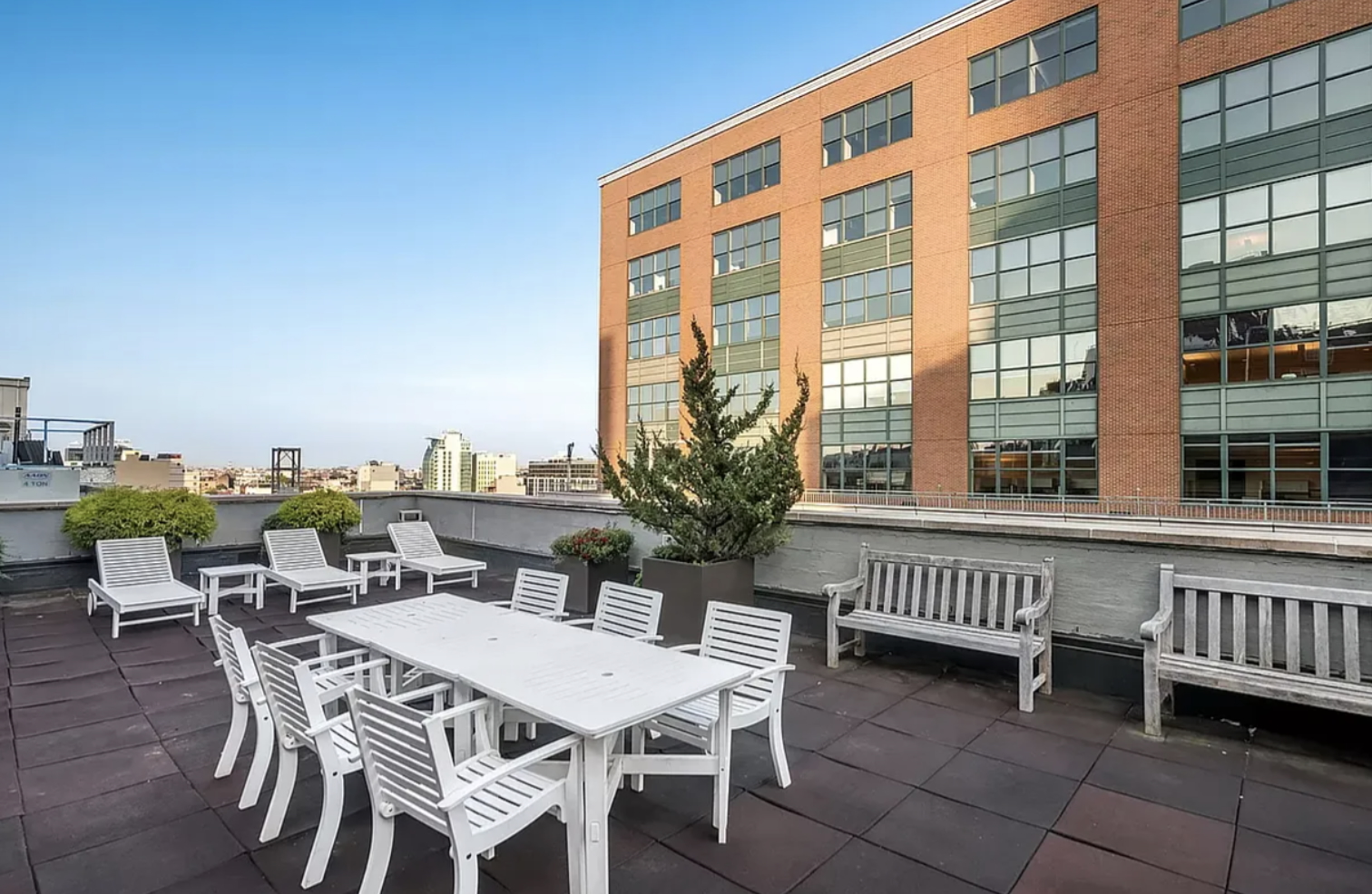 41-26 27th Street, Unit 4H Queens, NY 11101 - Photo 19 of 21 a view of a patio with a table and chairs and wooden floor