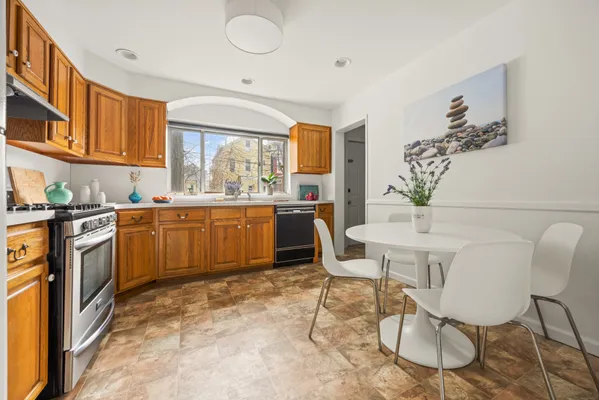 a kitchen with a table chairs sink and cabinets