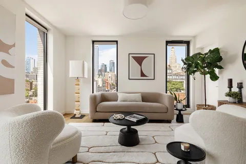 a living room with furniture and a potted plant
