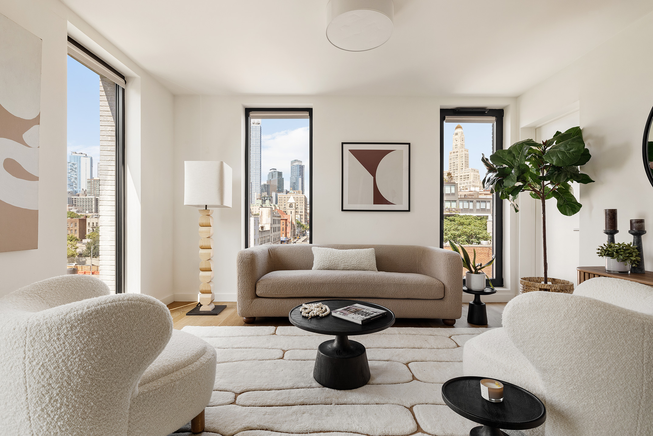 a living room with furniture and a potted plant