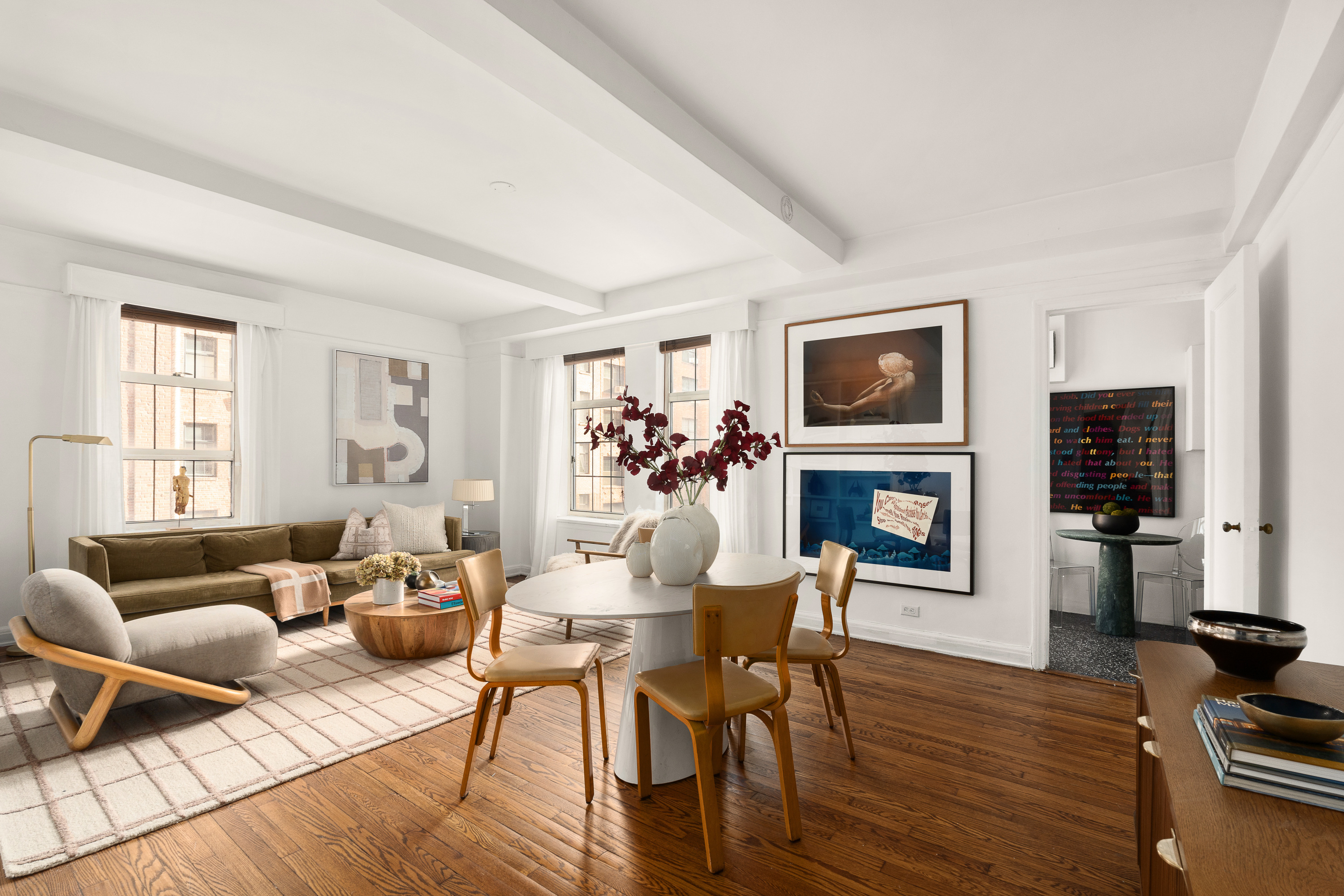 465 West 23rd Street, Unit 10A Manhattan, NY 10011 - Photo 2 of 12 a living room with furniture a fireplace and a flat screen tv