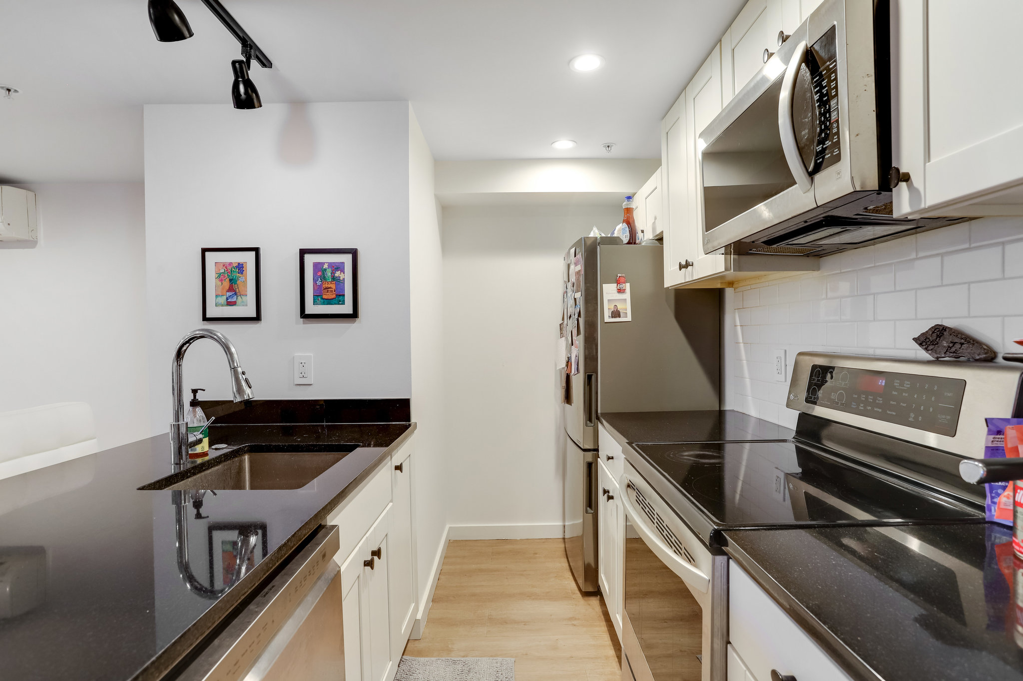 1920 35th Street Northwest Washington, DC 20007 - Photo 36 of 54 a kitchen with stainless steel appliances a sink a stove and cabinets