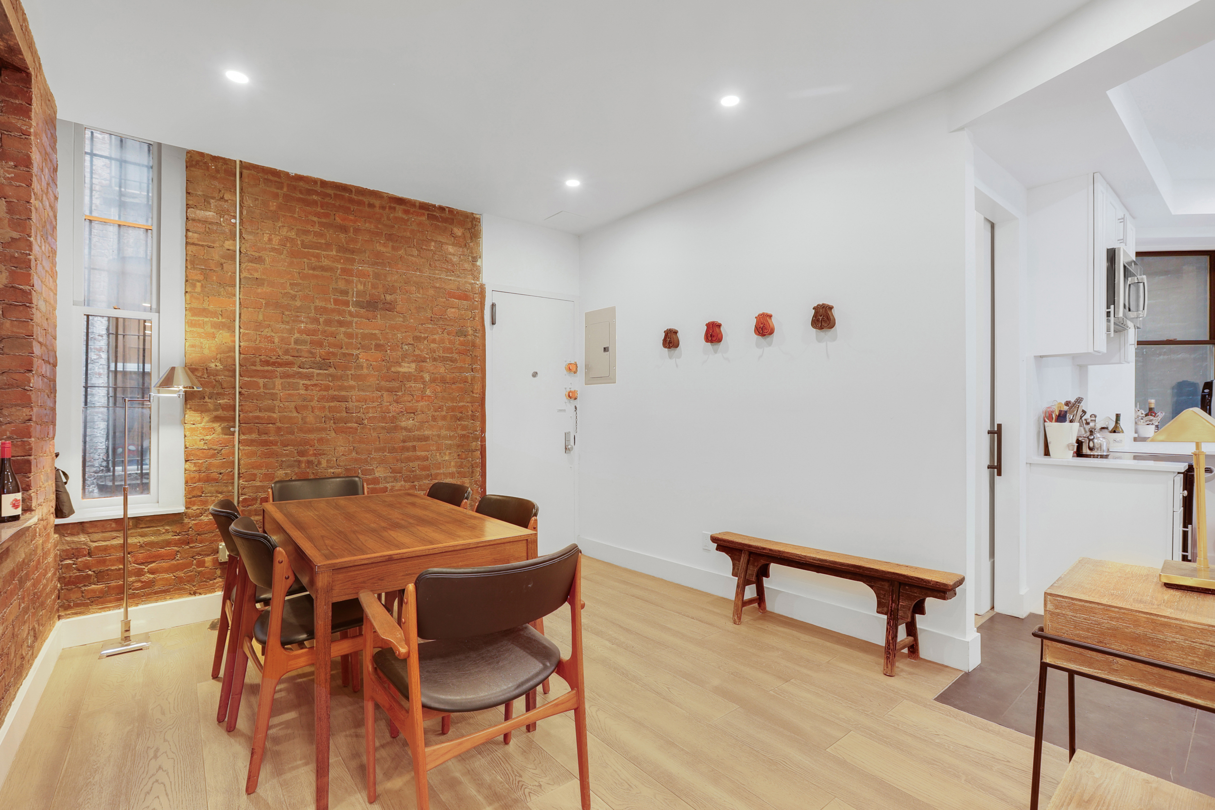 252 East 7th Street, Unit 7/8 Manhattan, NY 10009 - Photo 5 of 13 a view of a dining room with furniture and a window
