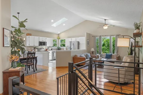 a living room with furniture and kitchen view