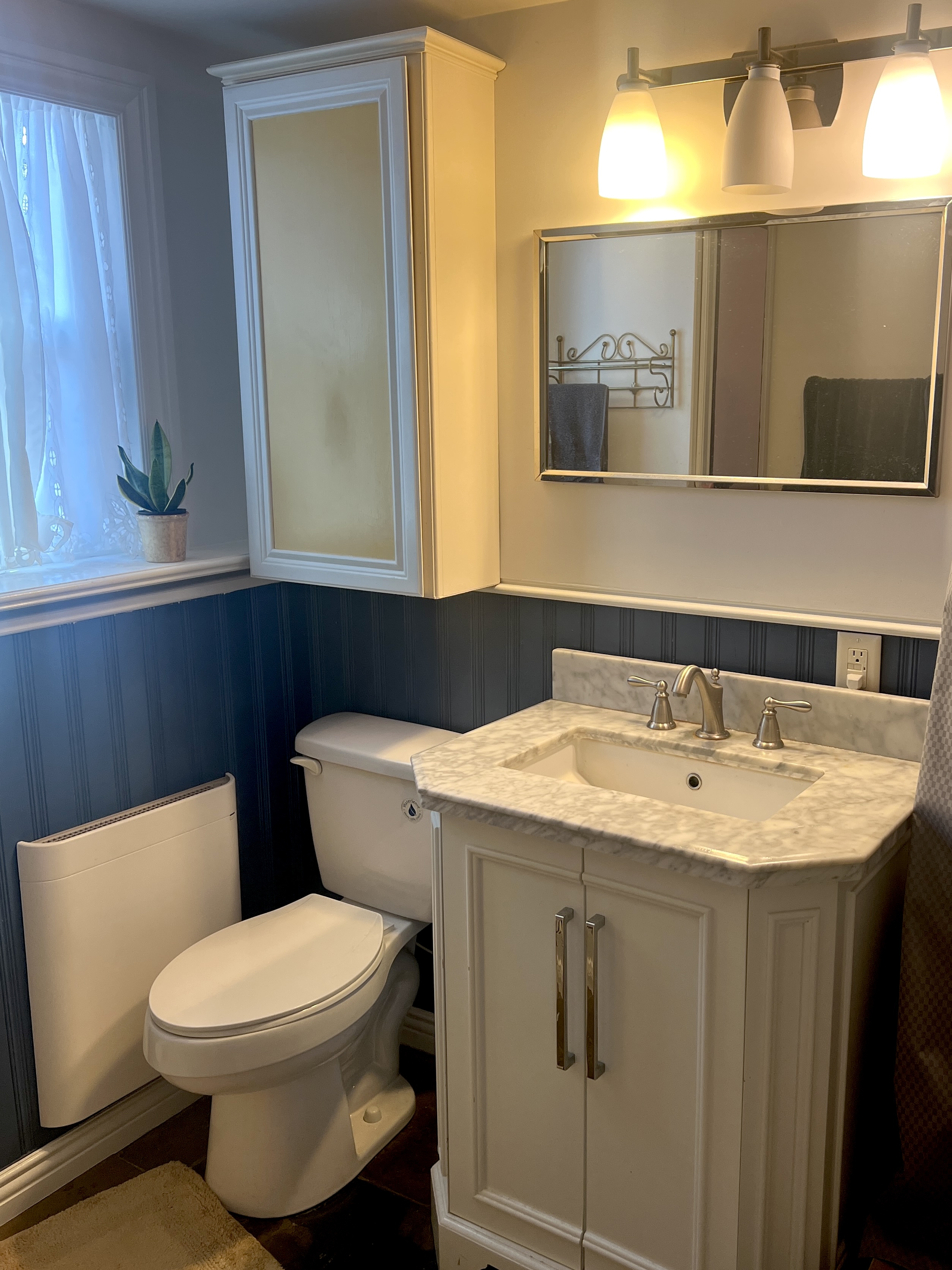 534 Hoover Street Oceanside, CA 92054 - Photo 27 of 31 a bathroom with a toilet sink and mirror