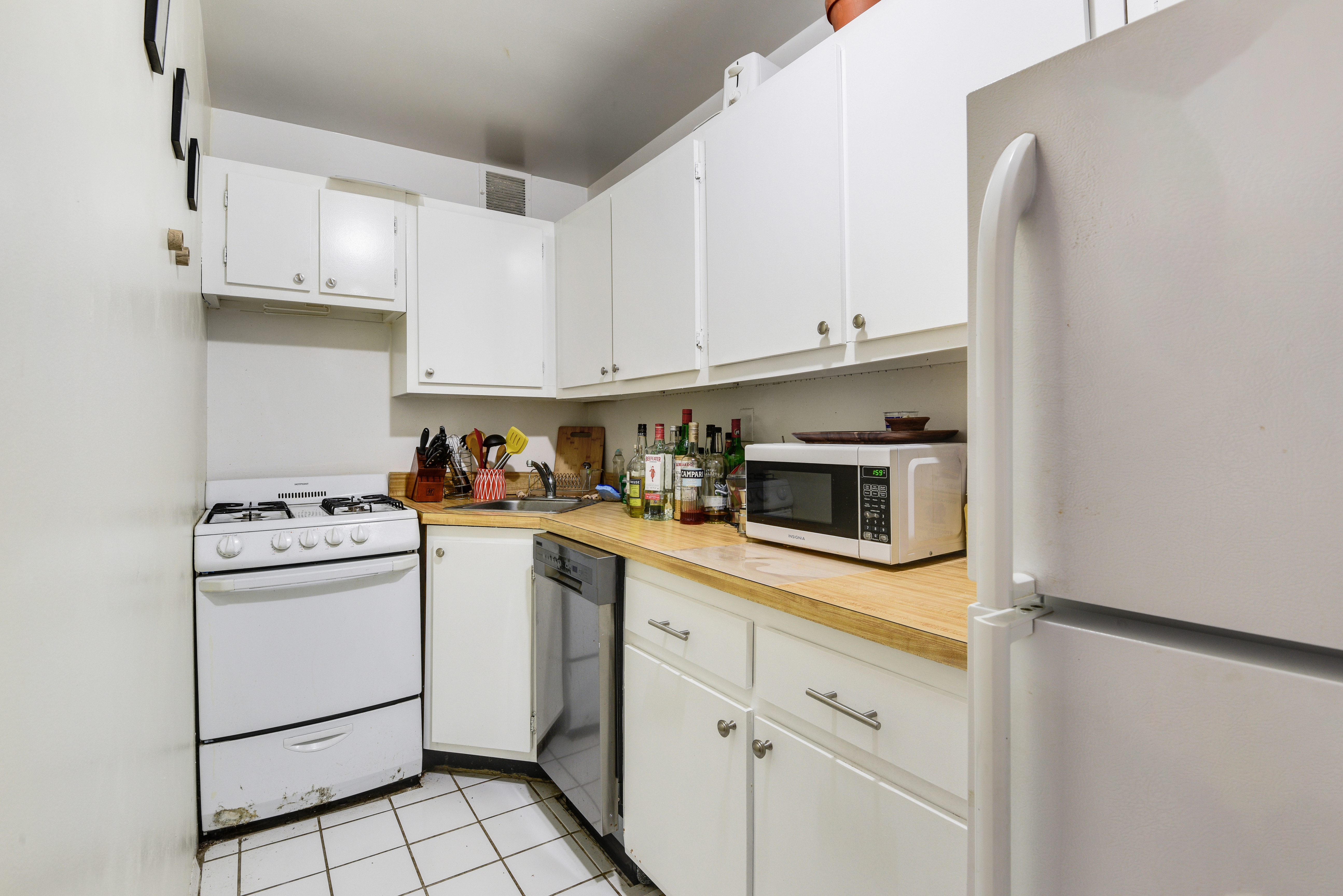 417 East 90th Street, Unit 1G Manhattan, NY 10128 - Photo 4 of 10 a kitchen with cabinets stainless steel appliances and a counter space