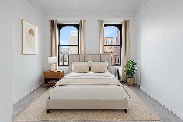 824 9th Avenue, Unit 5RN Manhattan, NY 10019 - Photo 1 of 11 a spacious bedroom with a bed and a potted plant