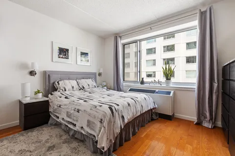 a bedroom with a bed and a window