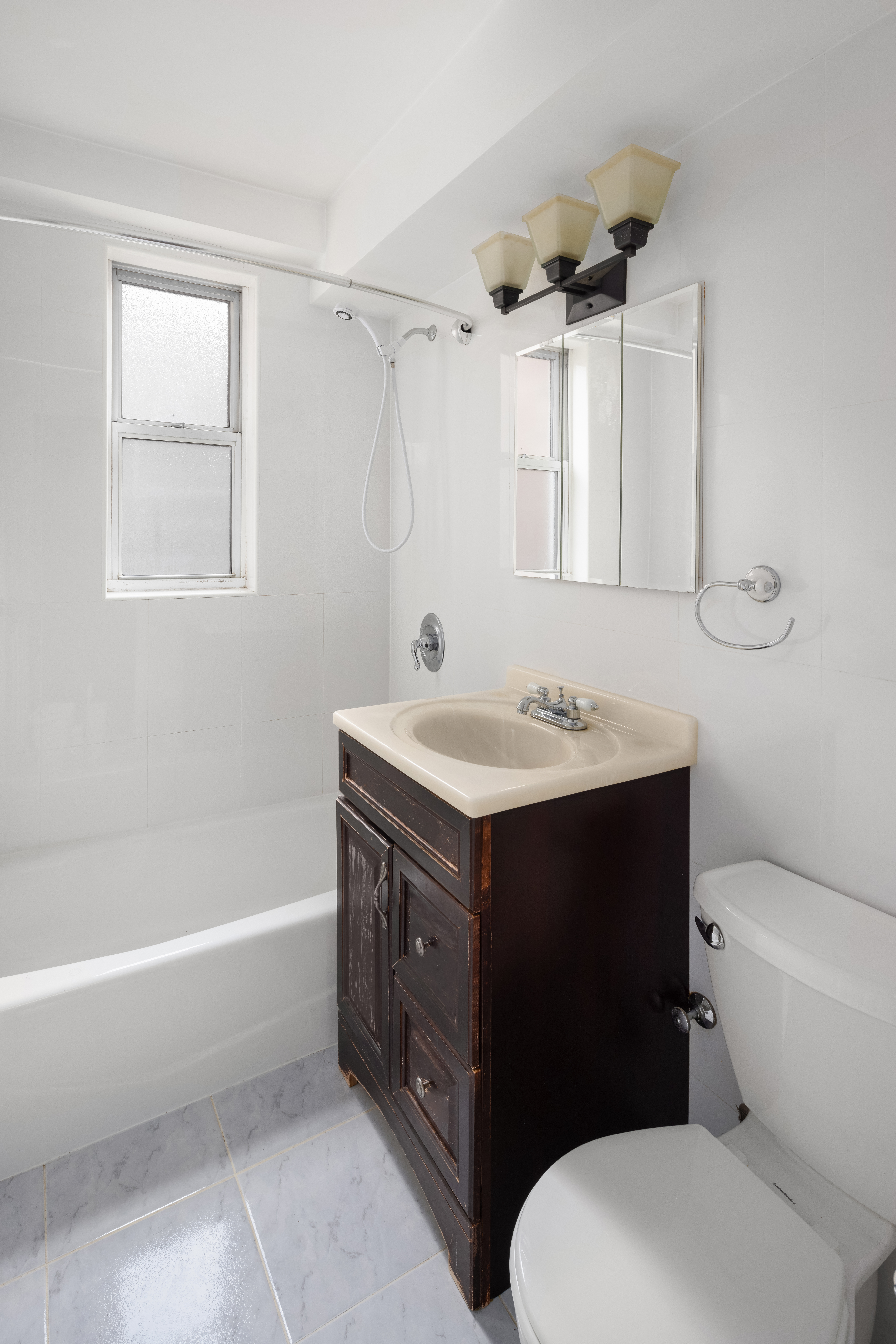110-50 71st Road, Unit 5N Queens, NY 11375 - Photo 5 of 8 a bathroom with a sink vanity mirror and toilet
