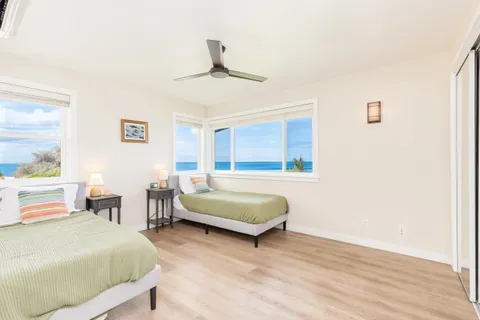 a bedroom with a bed wooden floor and window