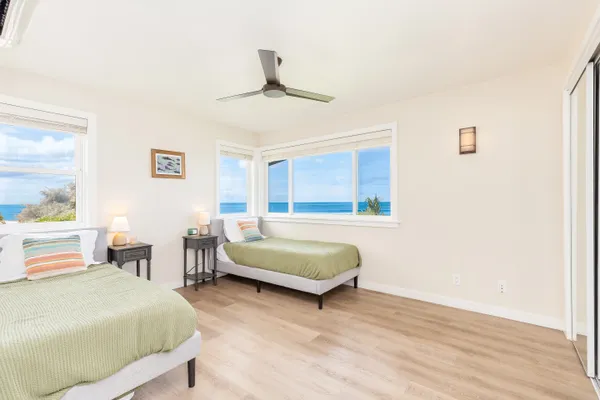 a bedroom with a bed wooden floor and window