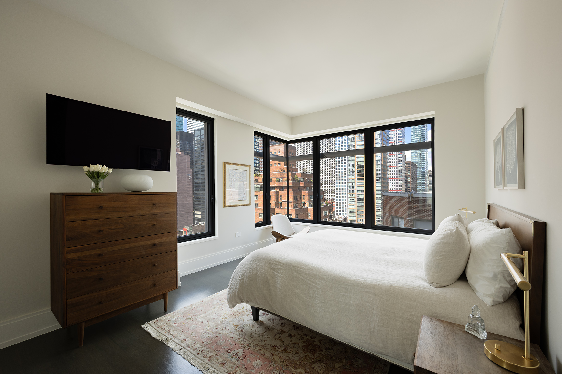 301 East 50th Street, Unit 16B Manhattan, NY 10022 - Photo 5 of 15 a bedroom with a bed and a flat screen television