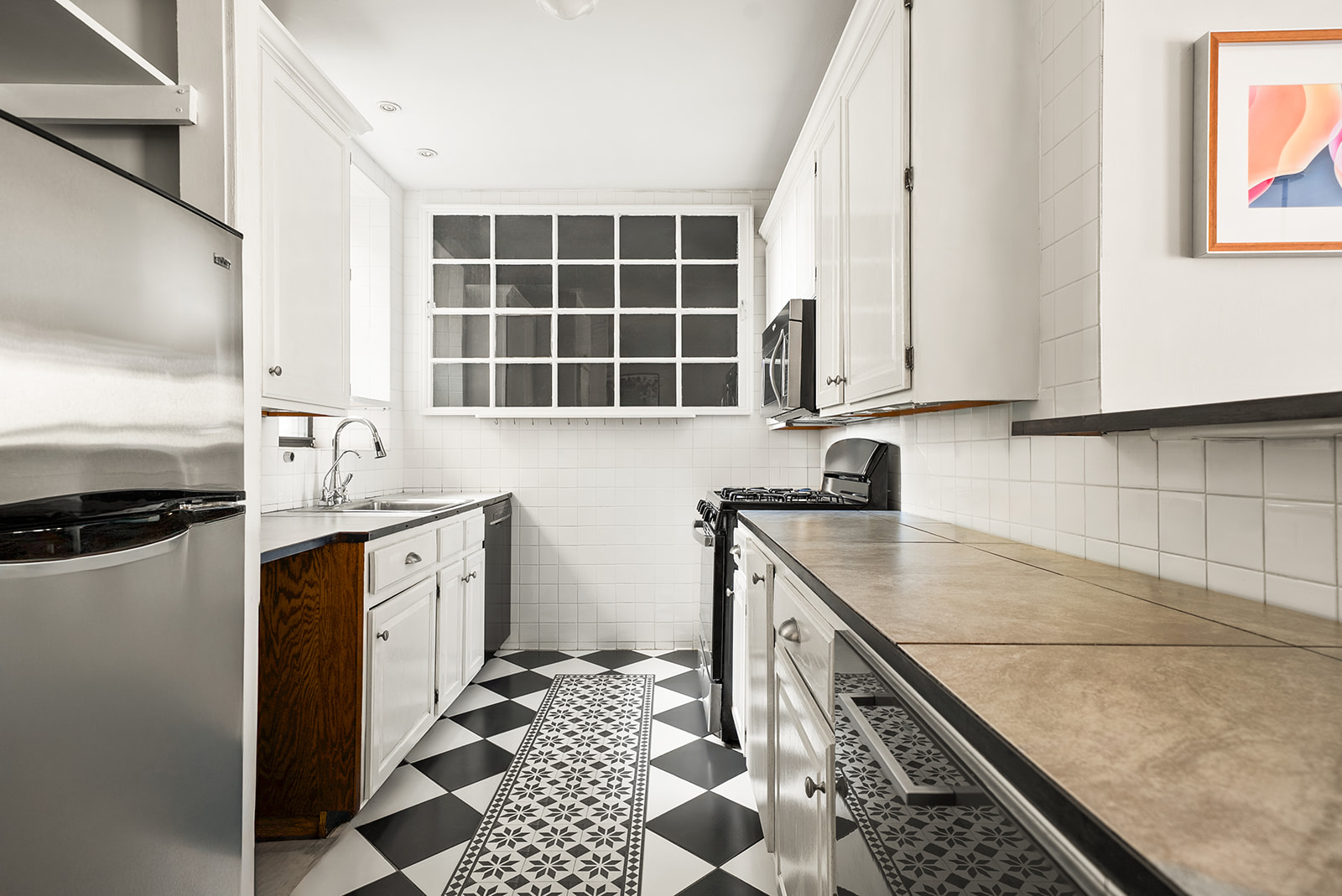 364 West 121st Street, Unit 4A Manhattan, NY 10027 - Photo 5 of 12 a kitchen with stainless steel appliances granite countertop a sink stove and cabinets