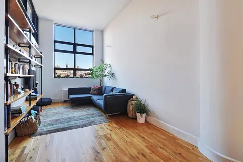 a living room with furniture and a book shelf