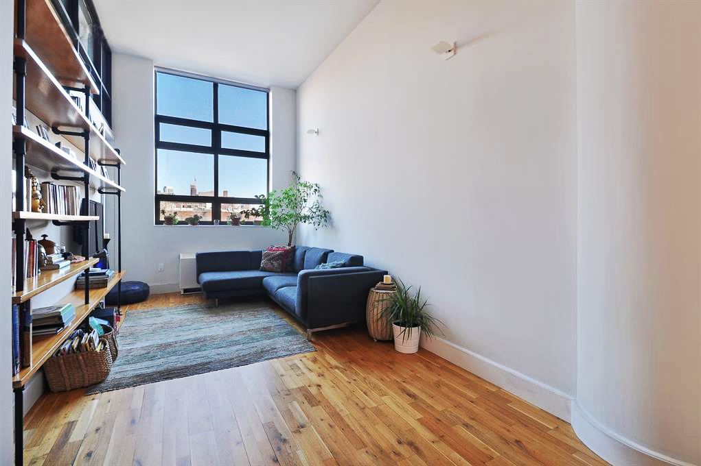 360 Furman Street, Unit 511 Brooklyn, NY 11201 - Photo 2 of 37 a living room with furniture and a book shelf
