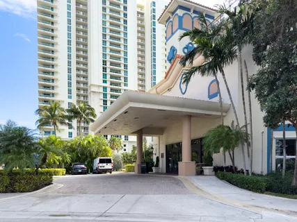 a view of a building with palm trees