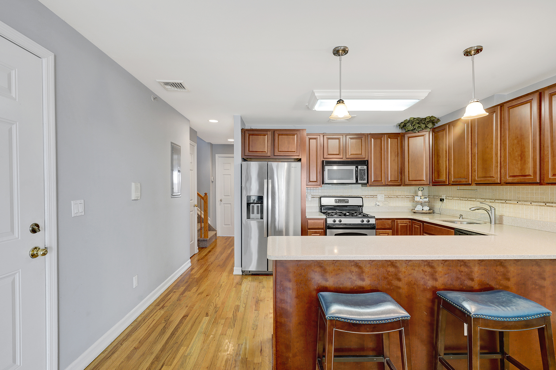 10220 Rockaway Beach Boulevard, Unit 3C Queens, NY 11694 - Photo 18 of 46 a kitchen with stainless steel appliances granite countertop a sink refrigerator and cabinets