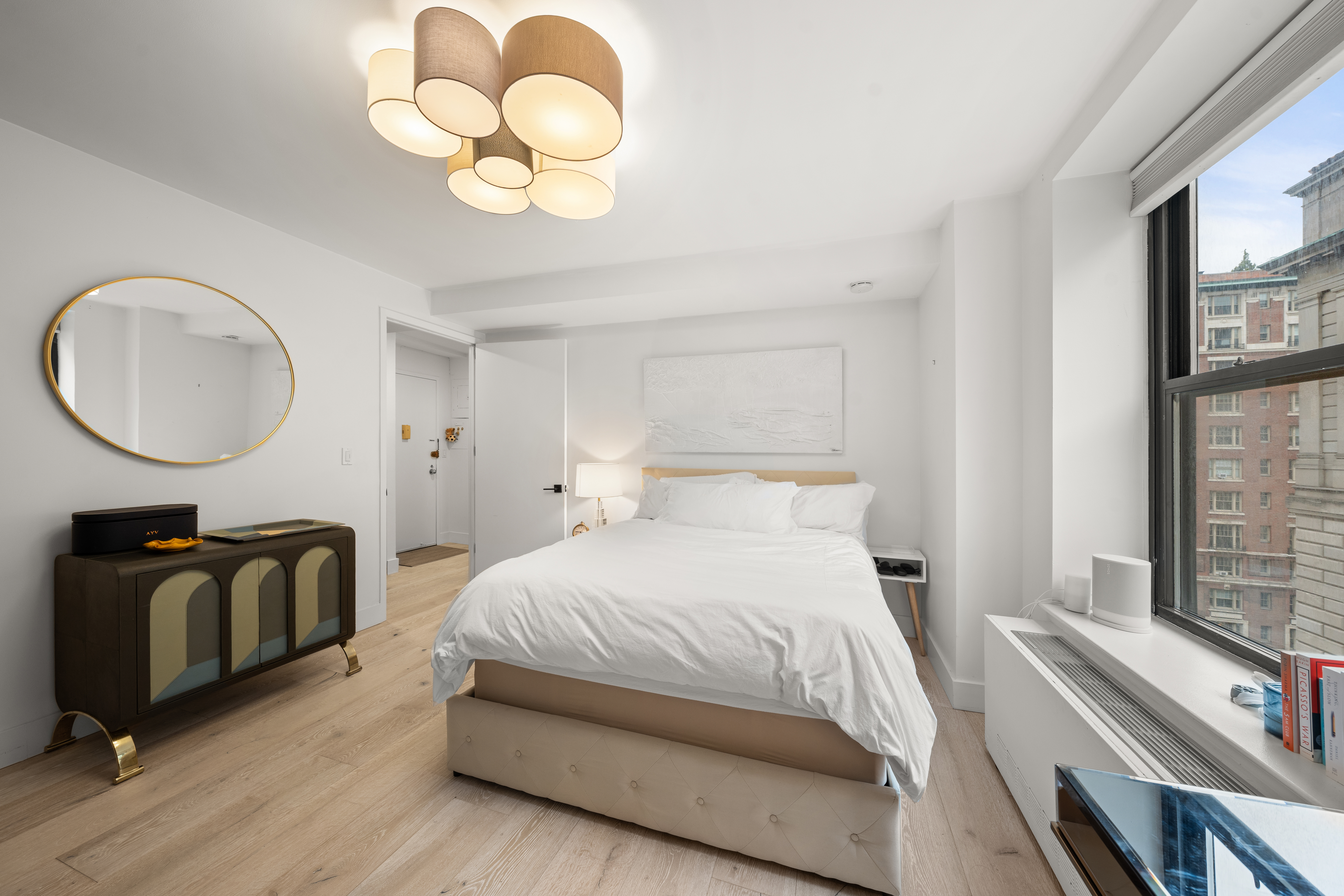 201 West 74th Street, Unit G8 Manhattan, NY 10023 - Photo 5 of 12 a bedroom with bed and a chandelier