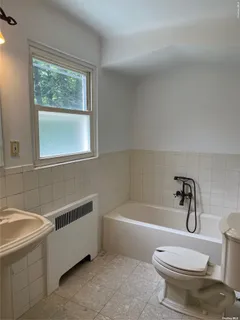 a view of a livingroom with wooden floor and window