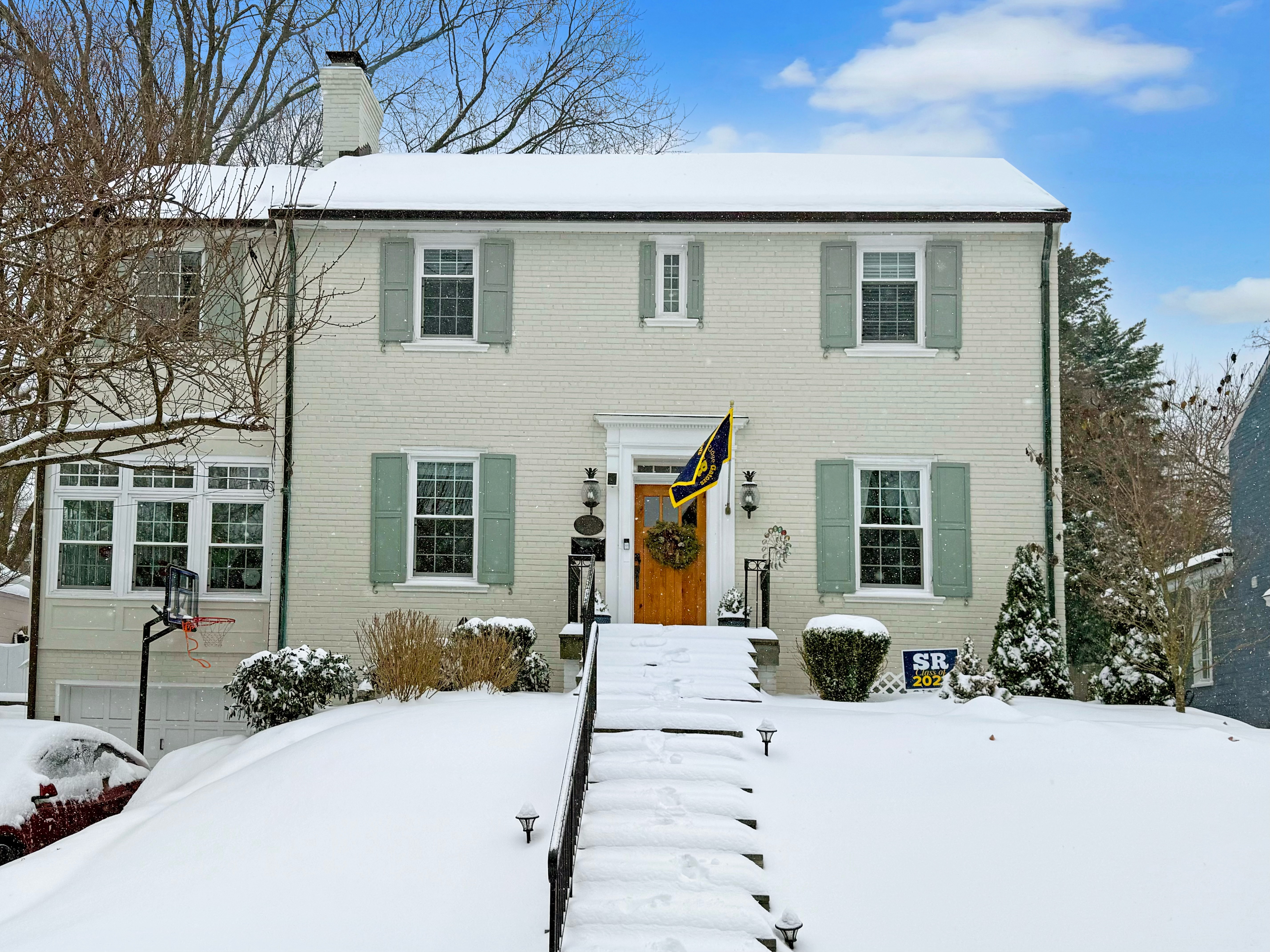 5002 Allan Road Bethesda, MD 20816 - Photo 1 of 9 a front view of a house with a yard covered in snow