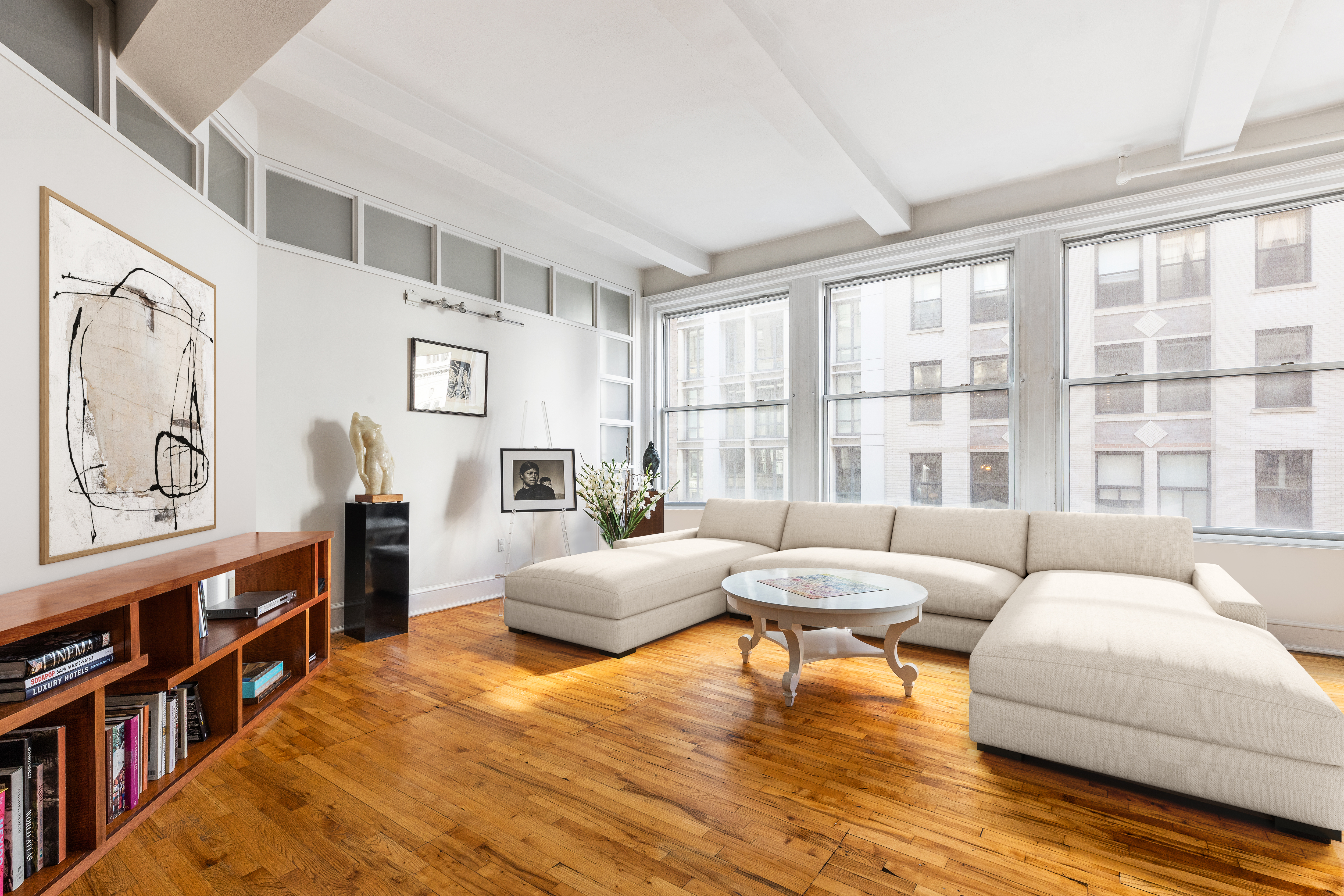 126 West 22nd Street, Unit 5N Manhattan, NY 10011 - Photo 2 of 13 a living room with furniture and a large window