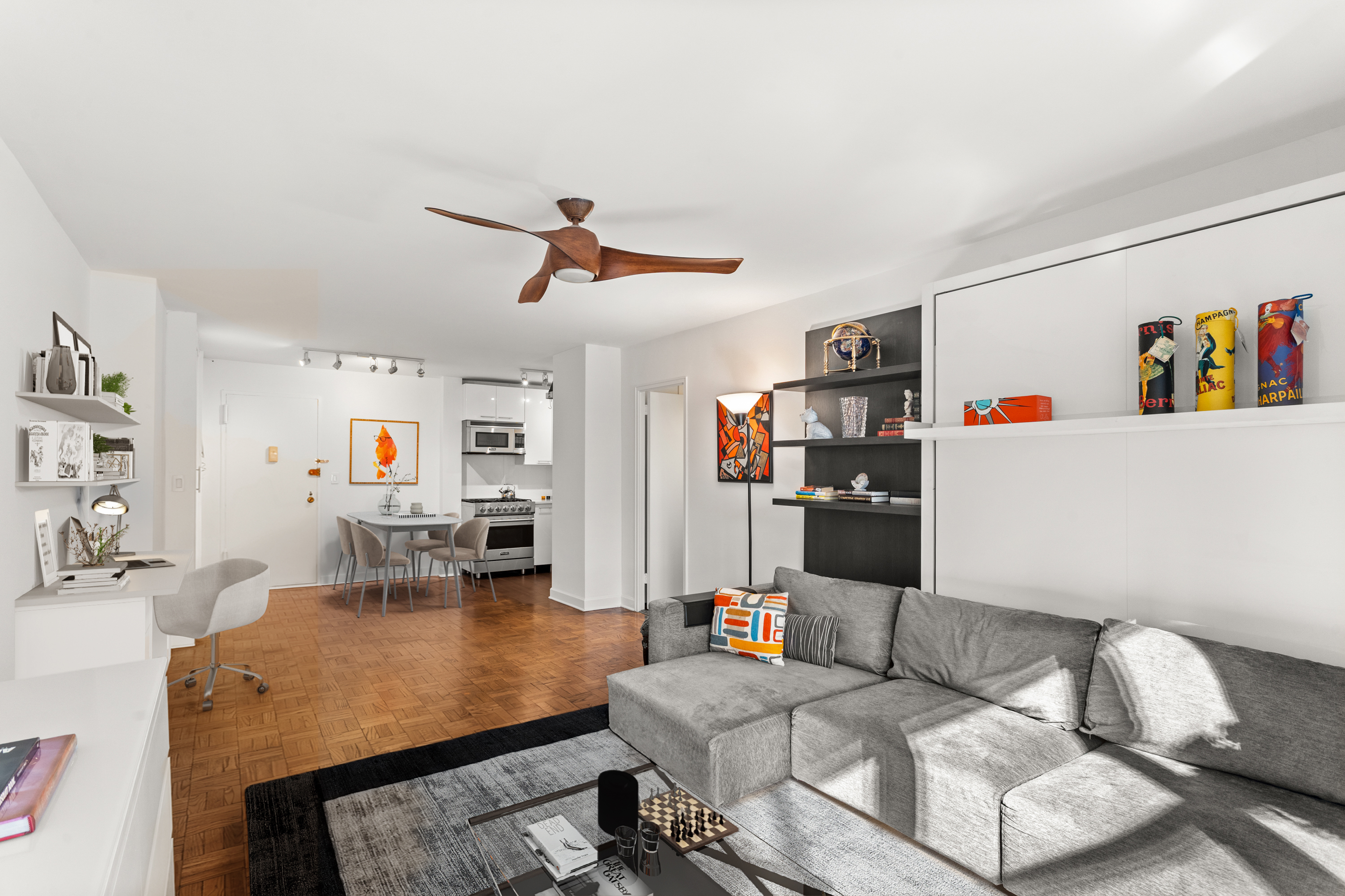 251 East 51st Street, Unit 5A Manhattan, NY 10022 - Photo 7 of 23 a living room with furniture and kitchen view