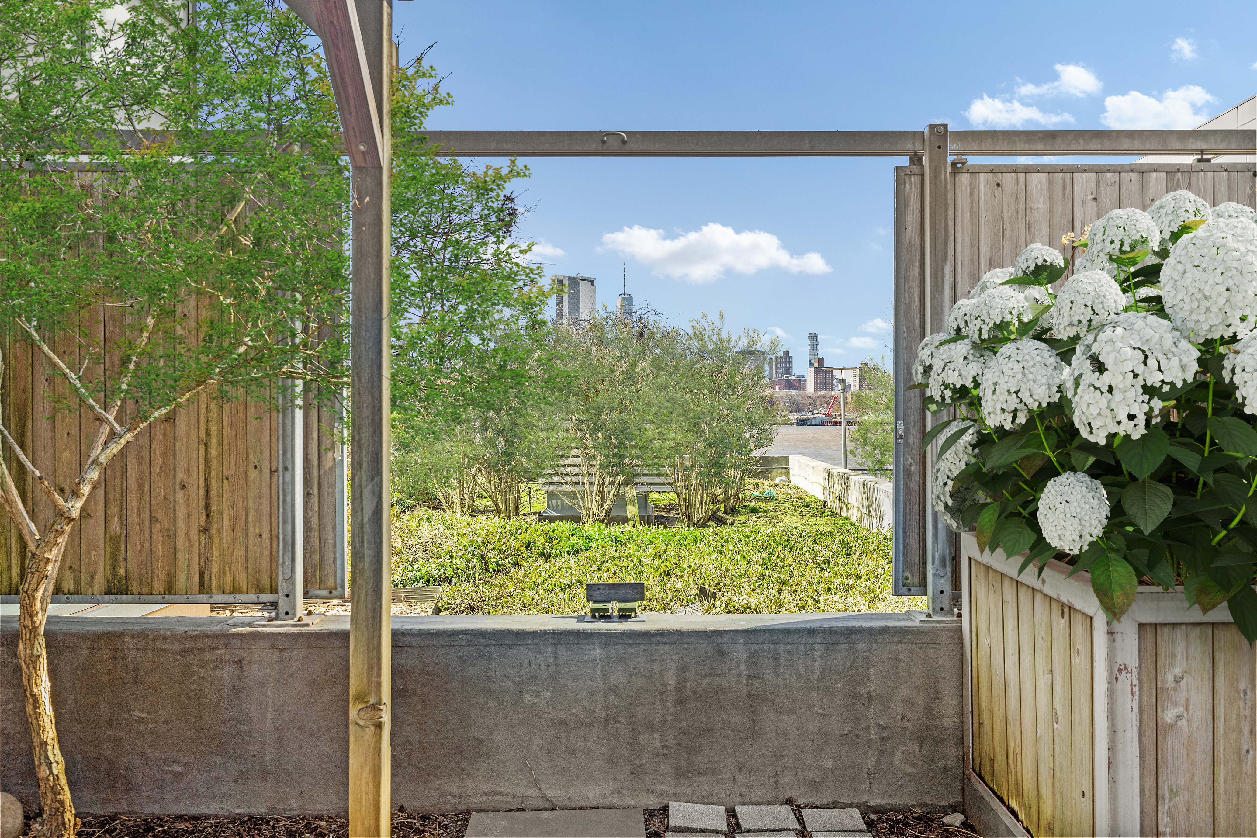 440 Kent Avenue, Unit 1B Brooklyn, NY 11249 - Photo 21 of 22 a front view of a house with a garden