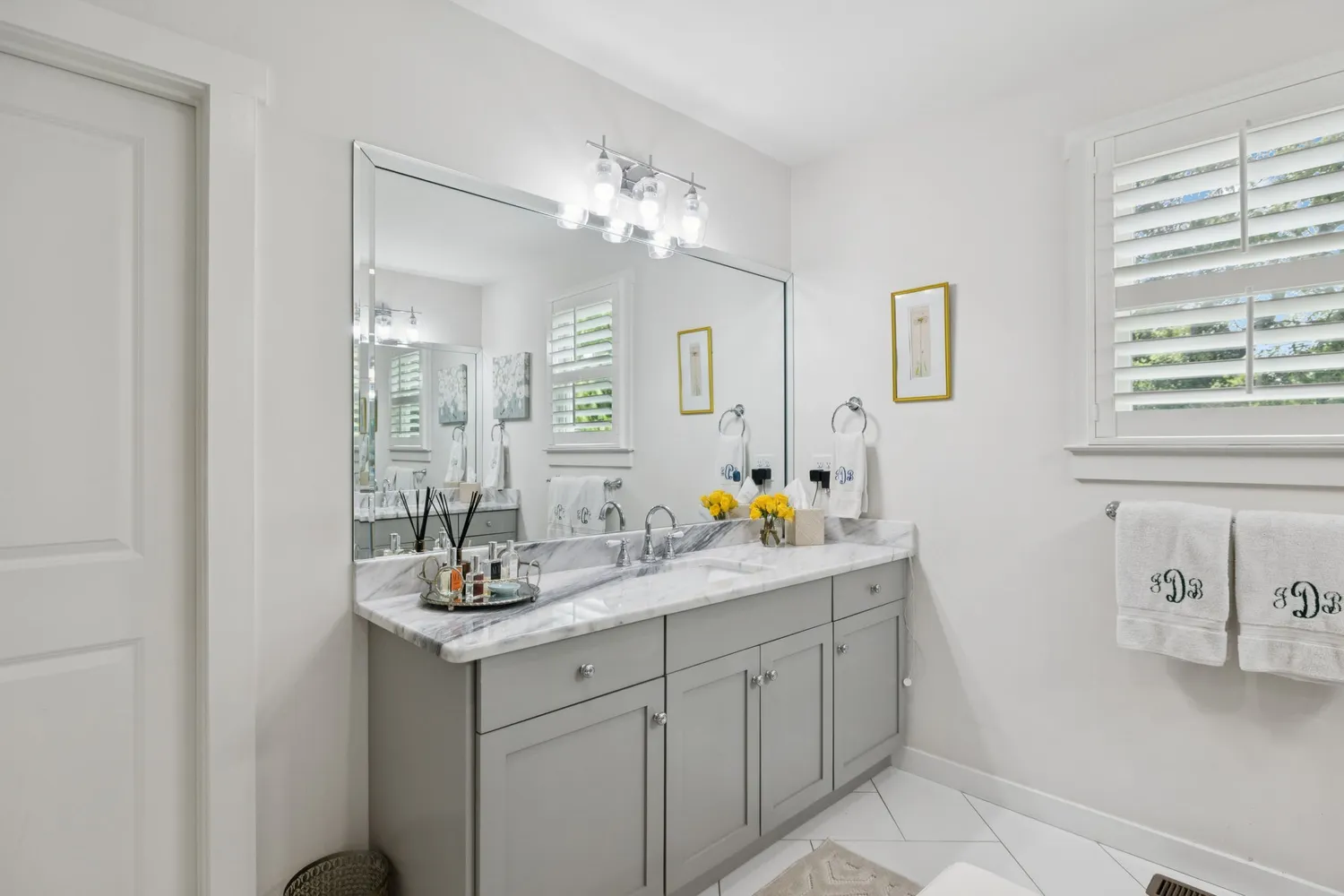 a bathroom with a double vanity sink and a mirror