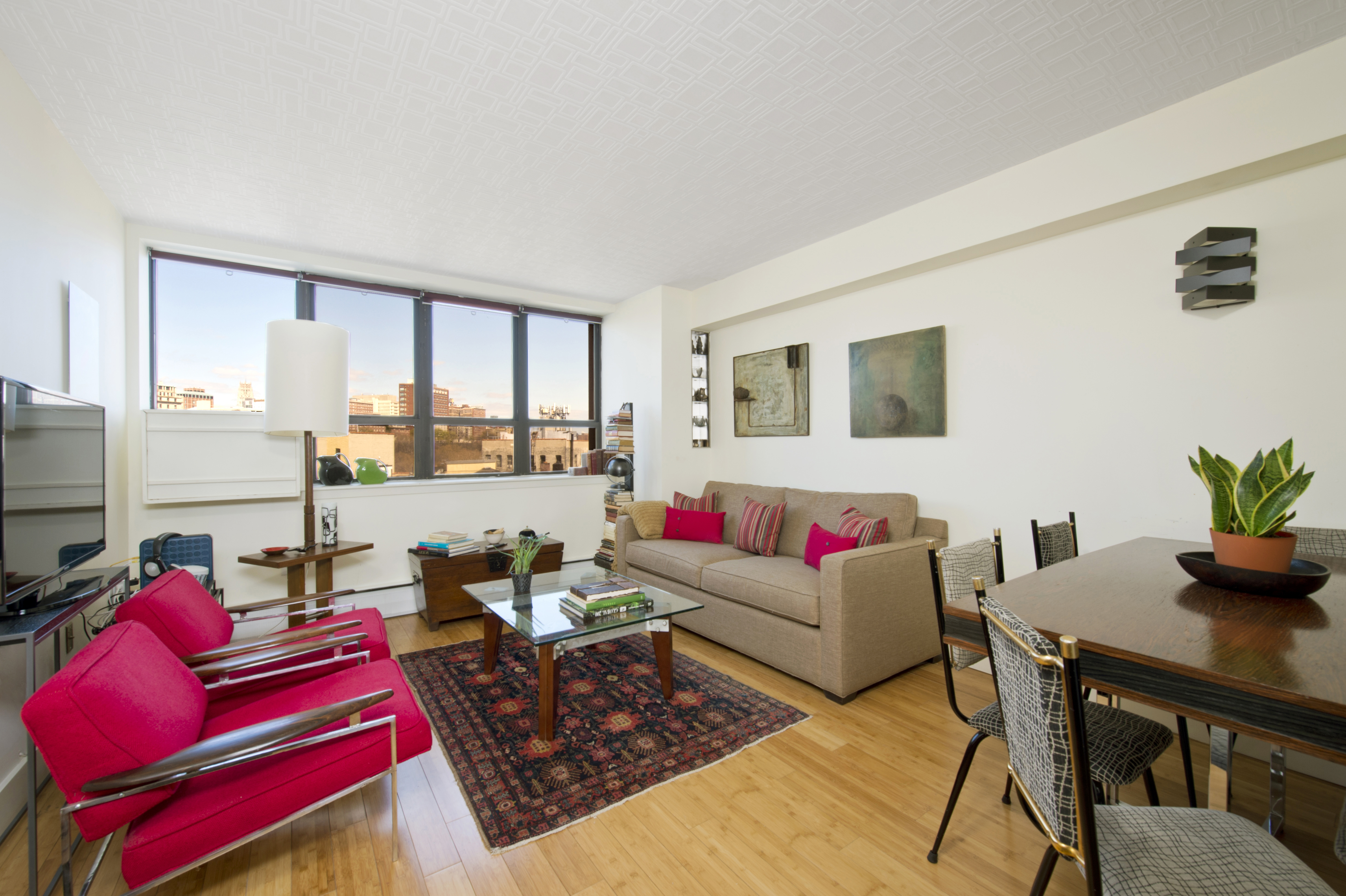 a living room with furniture and a floor to ceiling window
