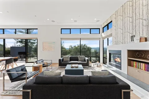 a living room with furniture fireplace and large window