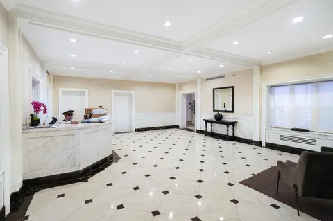 a living room with a bed furniture and decor