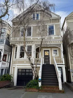 a front view of a residential apartment building with a yard