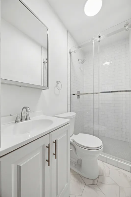 132 West 80th Street, Unit 4R Manhattan, NY 10024 - Photo 4 of 6 a bathroom with a sink toilet and shower