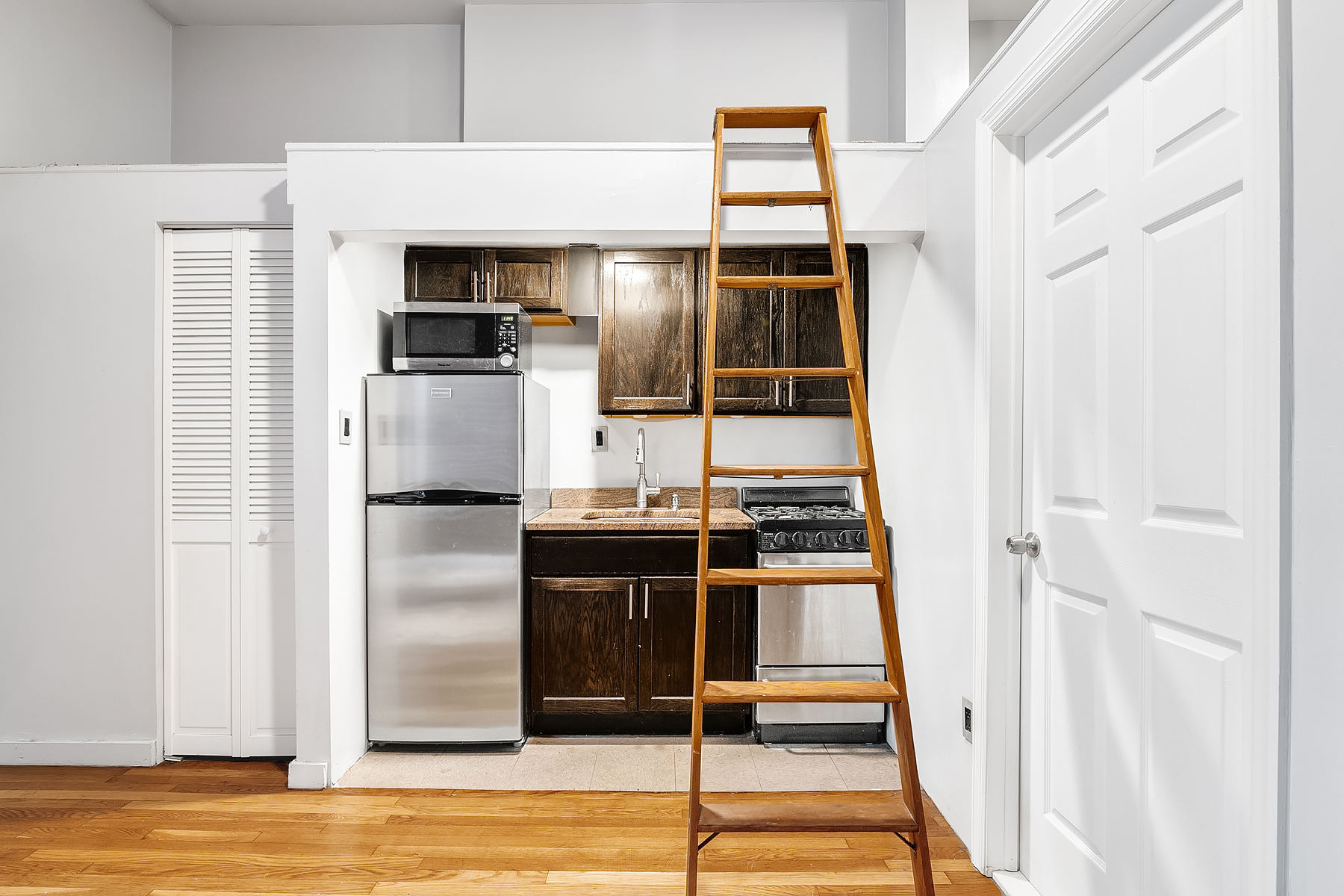 357 West 120th Street, Unit 1R Manhattan, NY 10027 - Photo 4 of 9 a kitchen with stainless steel appliances kitchen island granite countertop a refrigerator and a stove