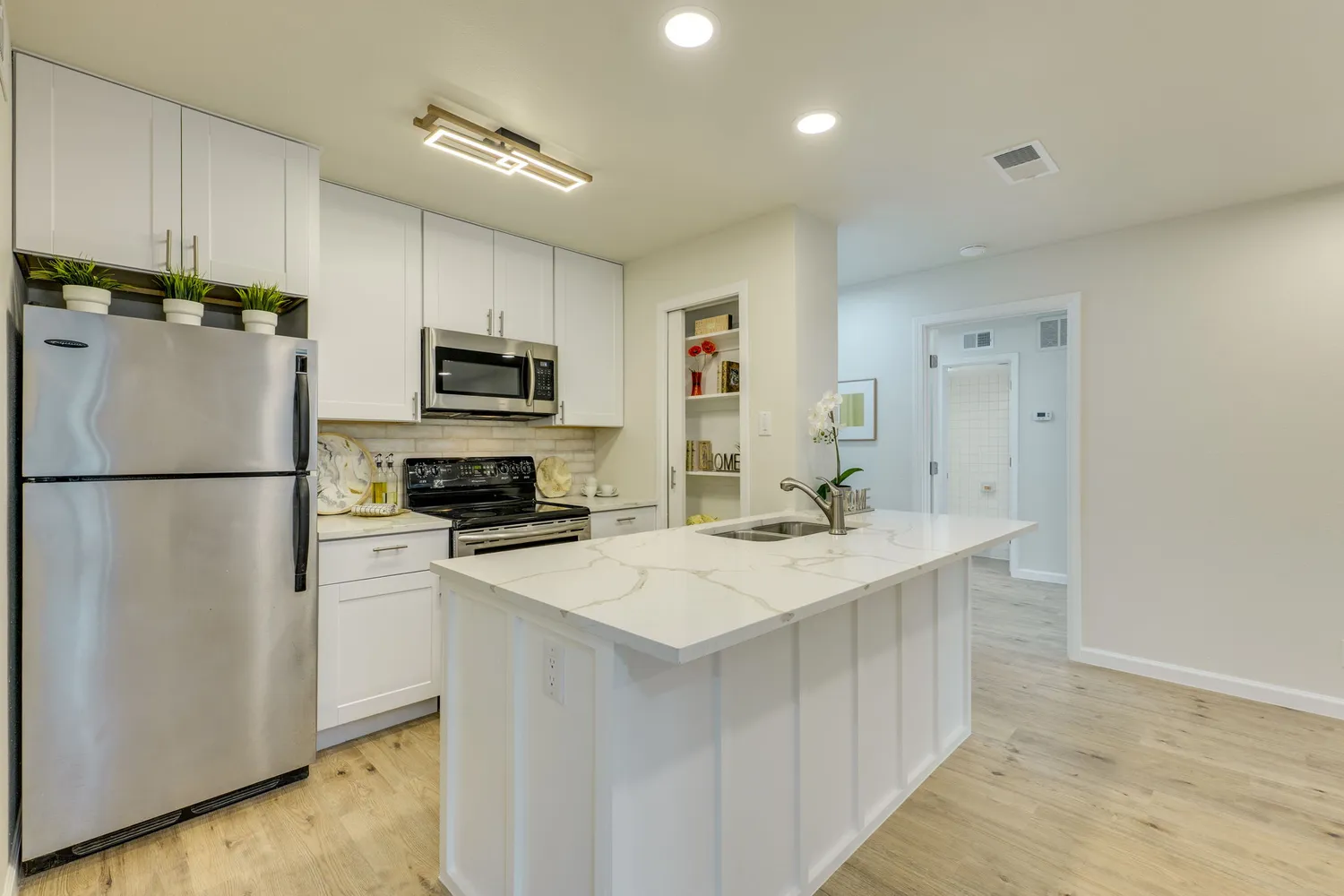 a kitchen with a sink and a refrigerator