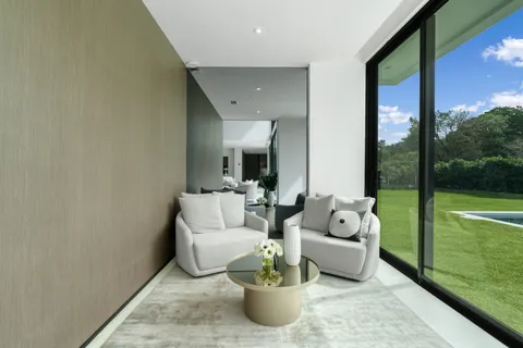 a living room with furniture and garden view