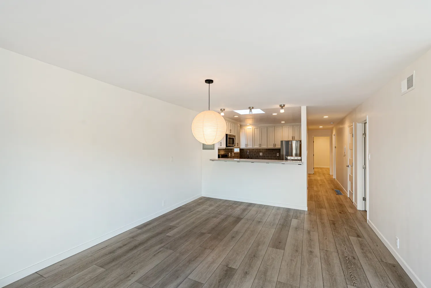 a view of a kitchen with wooden floor