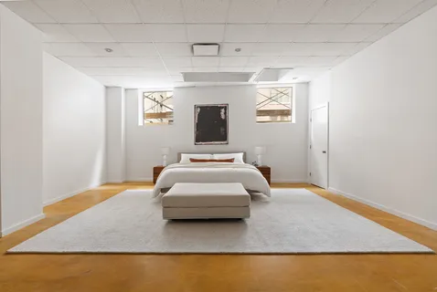 a bedroom with a bed and a night stand