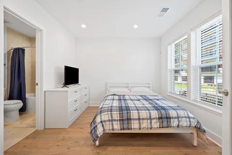 a bedroom with a bed and a flat screen tv