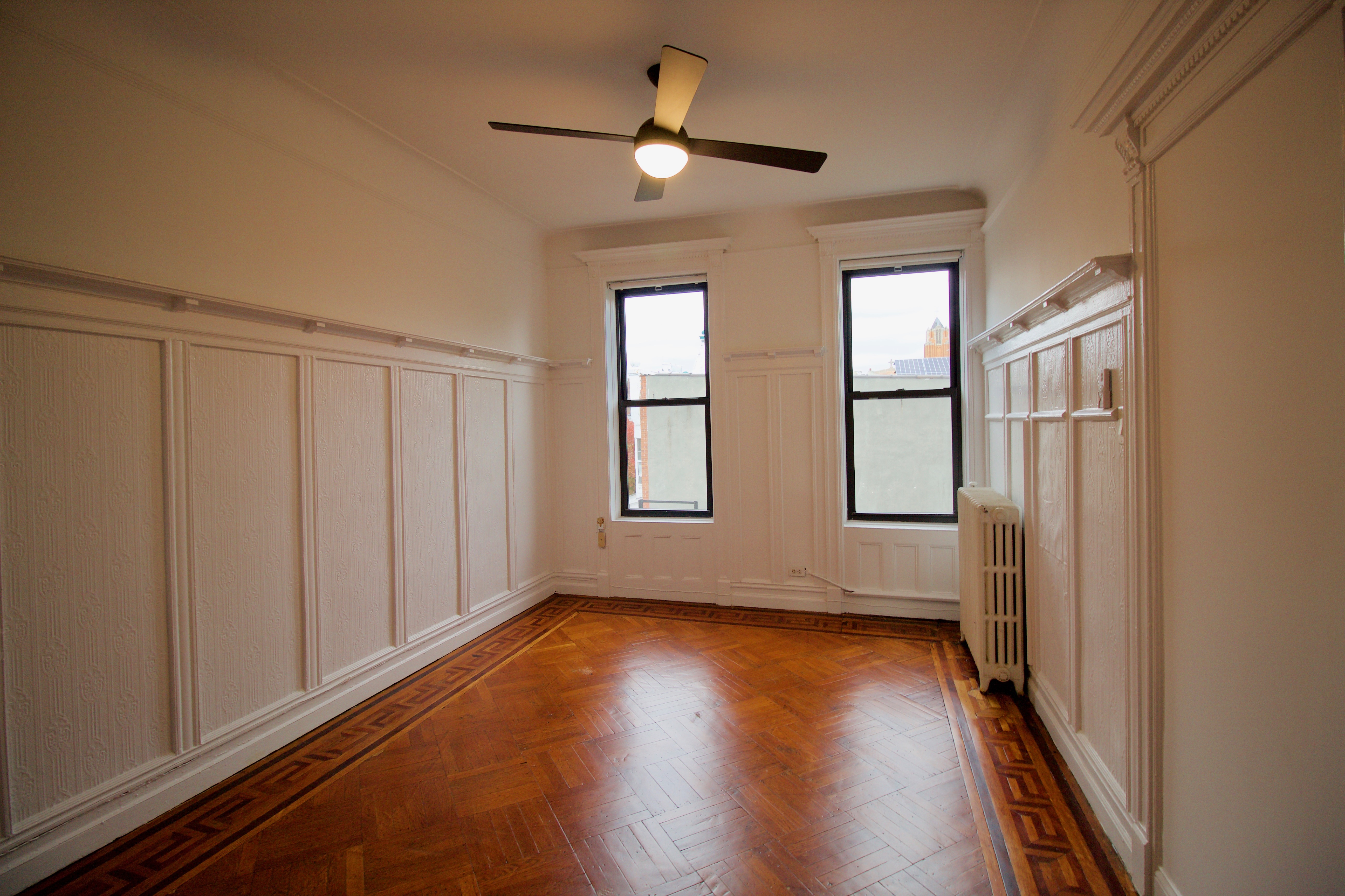 403 Caton Avenue, Unit 3 Brooklyn, NY 11218 - Photo 12 of 31 wooden floor in an empty room with a window
