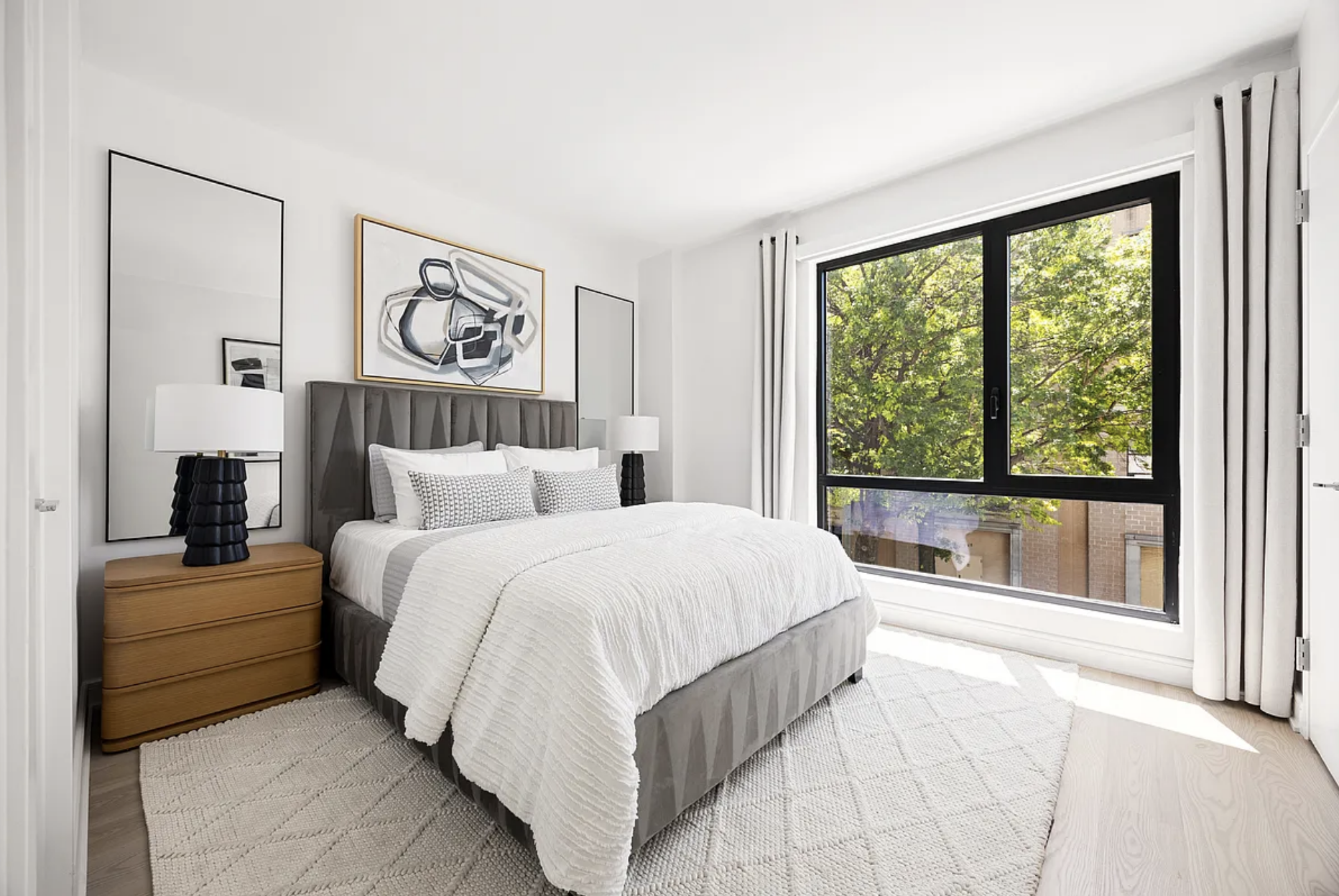 27-09 40th Avenue, Unit 3I Queens, NY 11101 - Photo 4 of 13 a spacious bedroom with a bed and a large window
