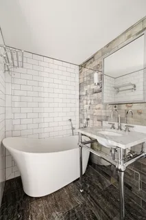 a white bath tub sitting in a bathroom