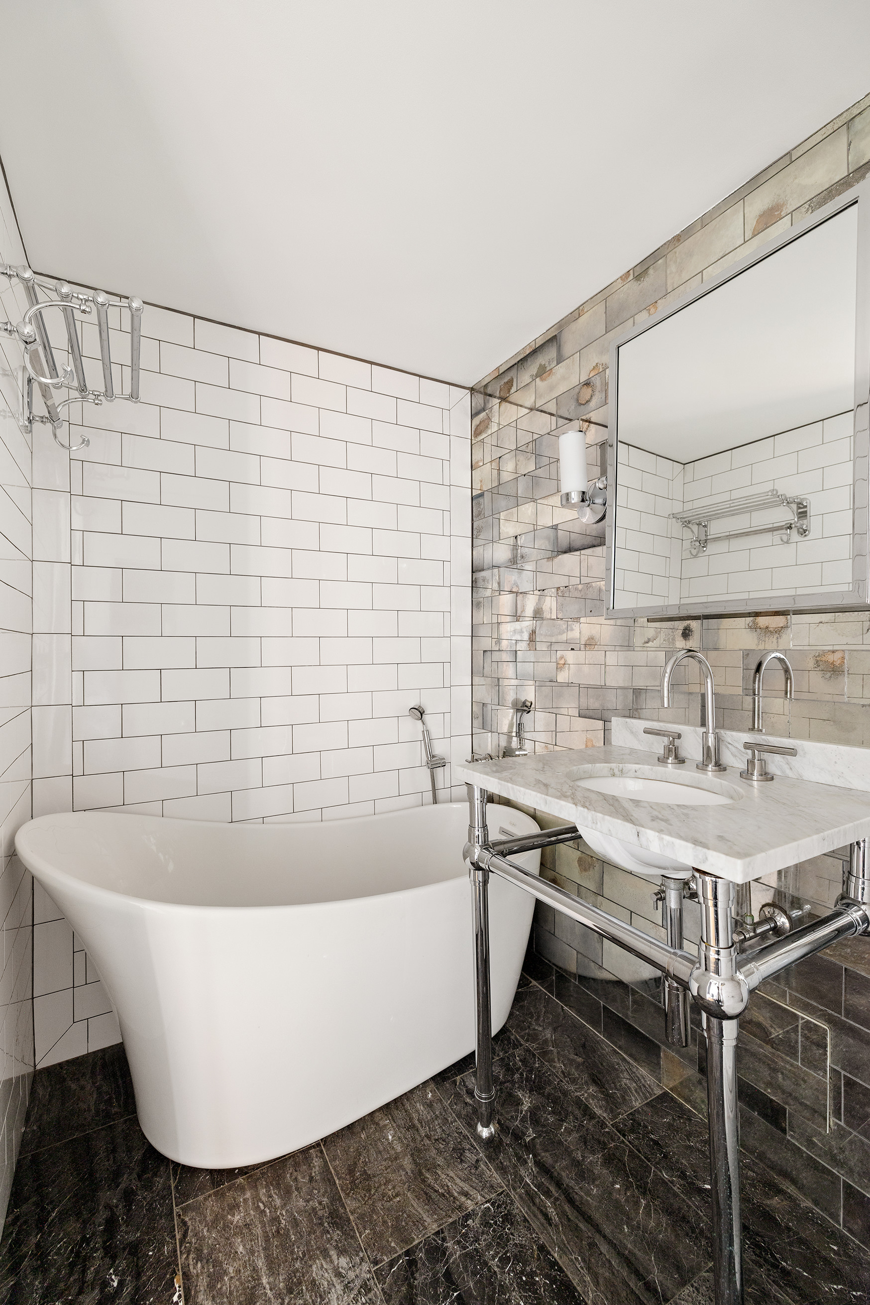10 East End Avenue, Unit 18D Manhattan, NY 10075 - Photo 14 of 21 a white bath tub sitting in a bathroom